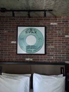 Artwork above the bed. Looks like an enlarged record of Booker T and the MG's "Green Onions".